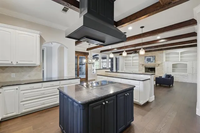 a kitchen with sink cabinets and stove top oven