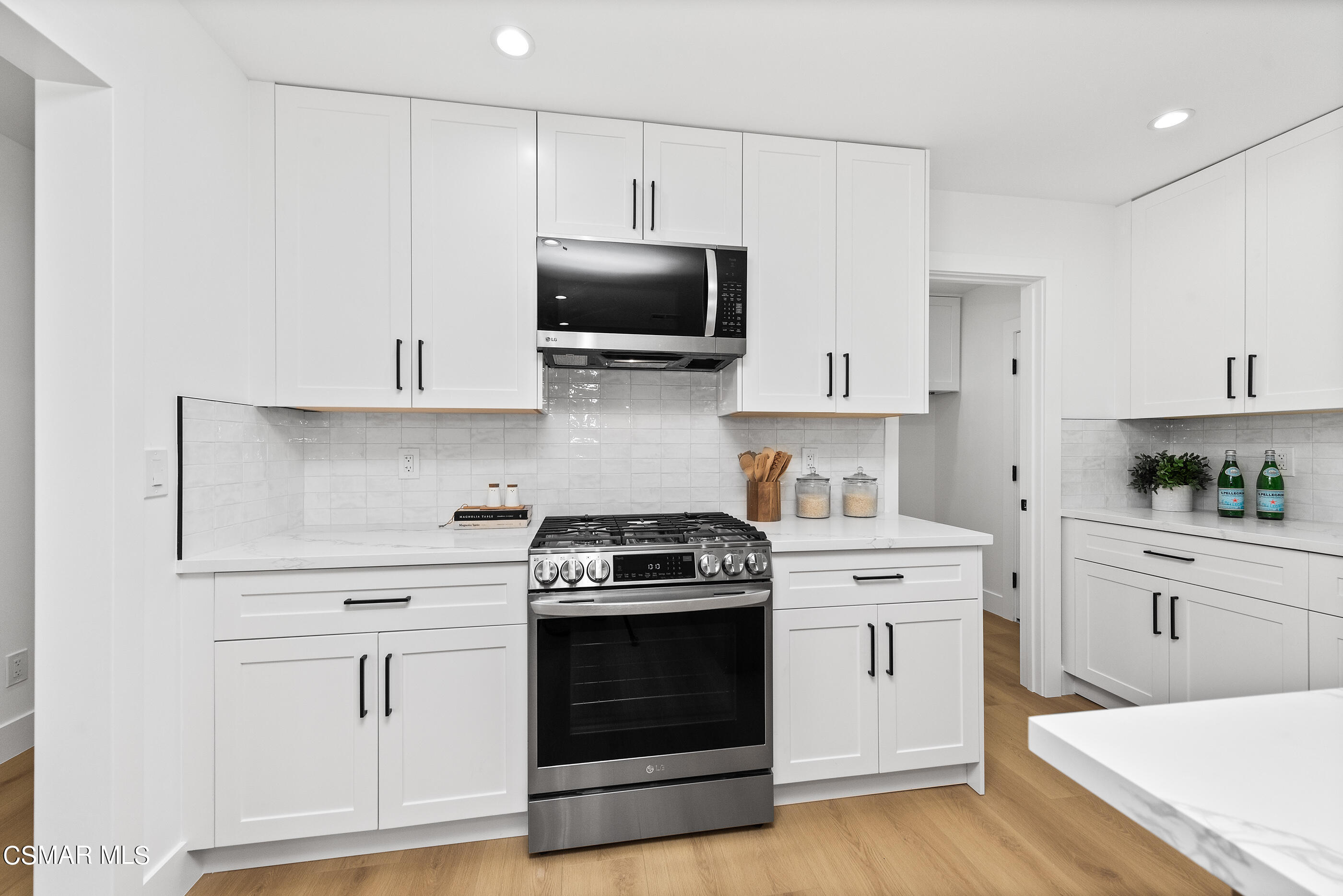 3343 Austin Avenue Simi Valley, CA 93063 - Photo 14 of 40 a kitchen with white cabinets and stainless steel appliances
