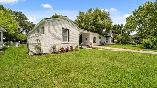 a front view of house with yard and trees