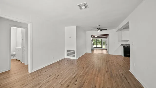 wooden floor in an empty room with a window