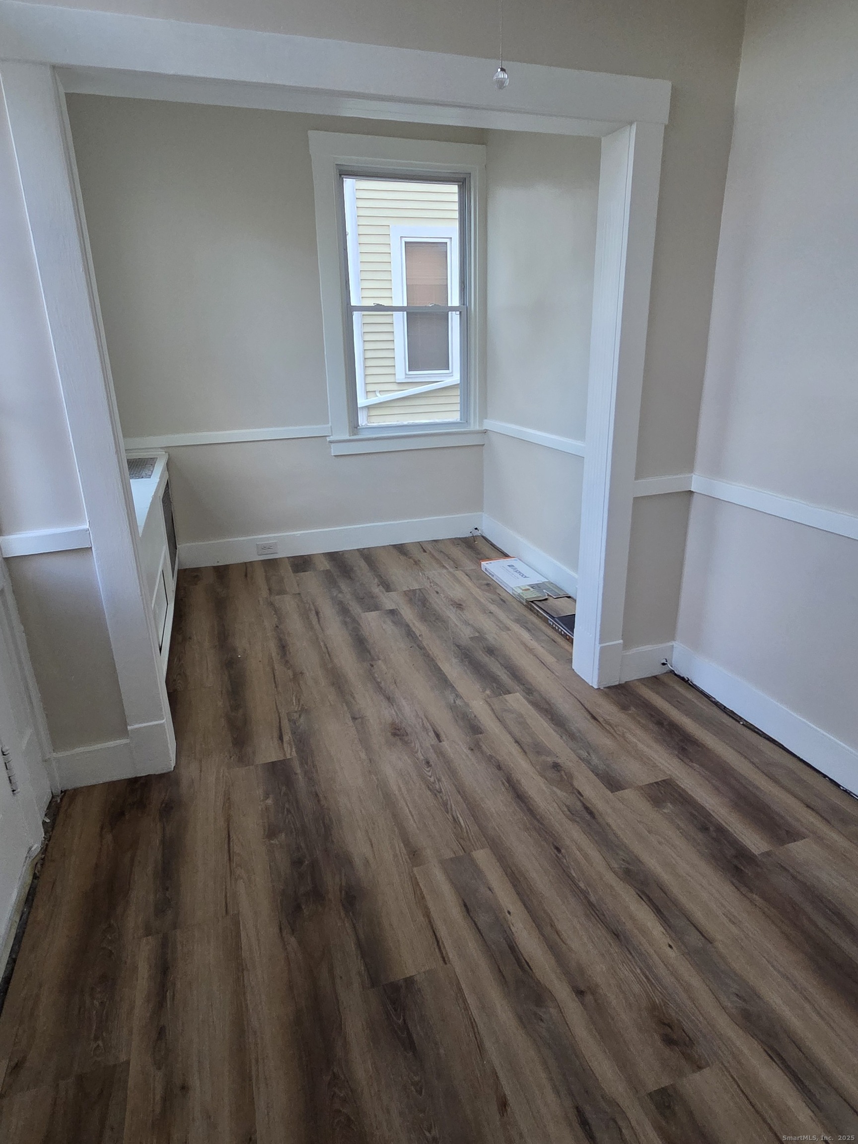 32 Channing Street, Unit 1 New London, CT 06320 - Photo 4 of 13 an empty room with wooden floor and windows