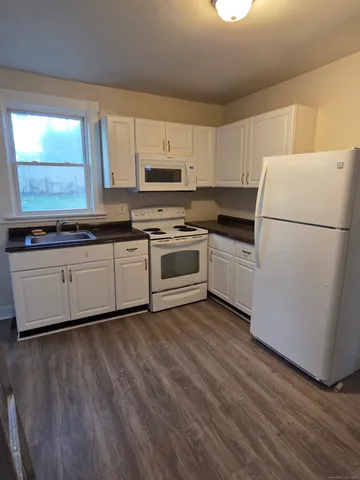 a kitchen with a sink a refrigerator and window