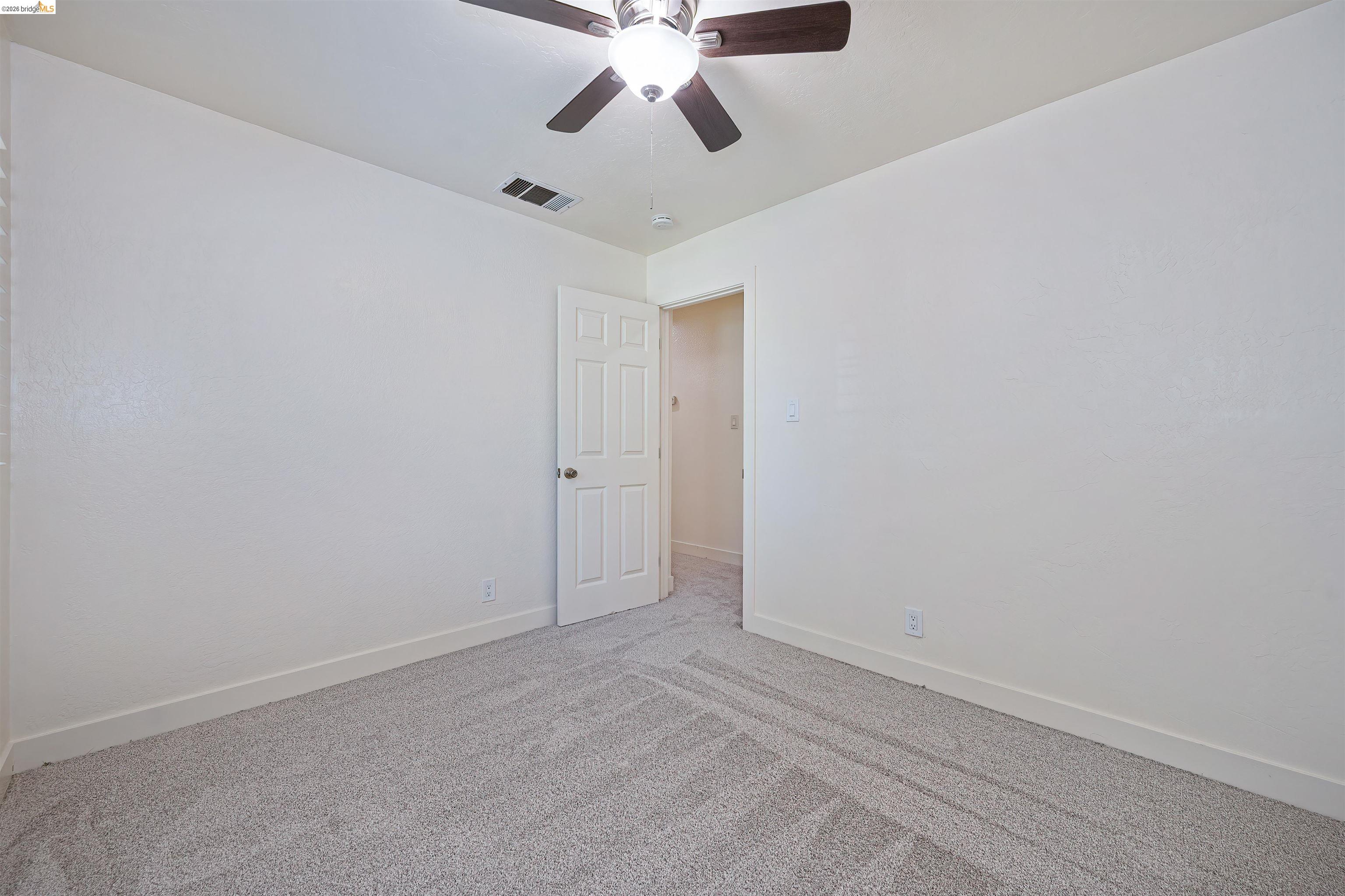 10474 Sheldon Road Elk Grove, CA 95624 - Photo 39 of 83 Neutral-toned wall finishes with light gray carpeting provide a versatile backdrop