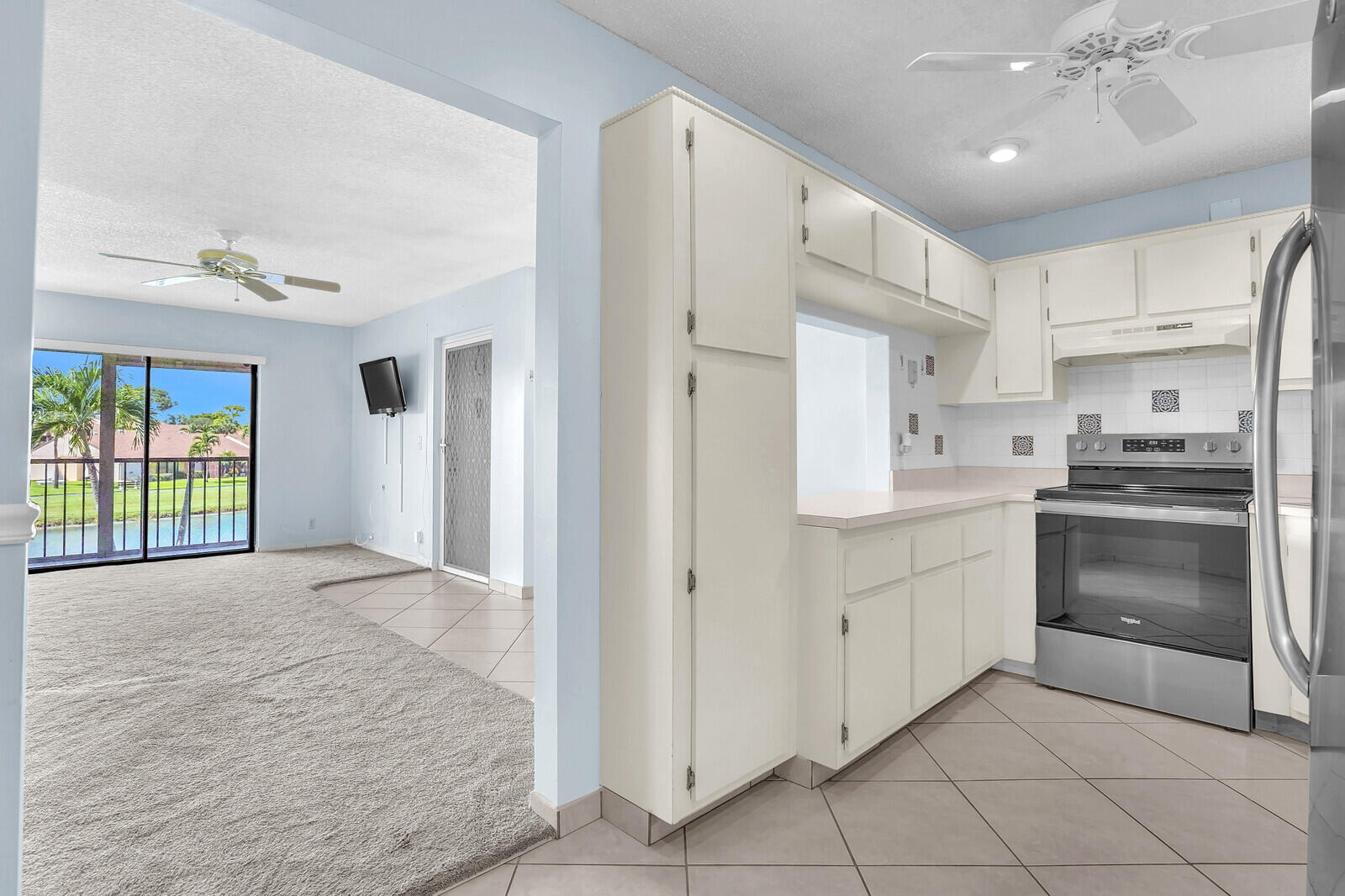 826 Sky Pine Way, Unit G2 Greenacres, FL 33415 - Photo 14 of 30 a kitchen with white cabinets and stainless steel appliances