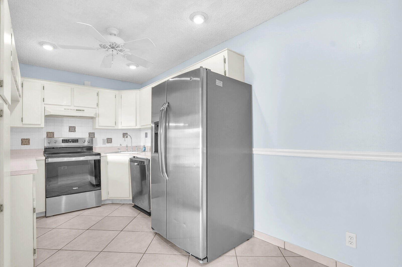826 Sky Pine Way, Unit G2 Greenacres, FL 33415 - Photo 15 of 30 a kitchen with stainless steel appliances a refrigerator sink and cabinets