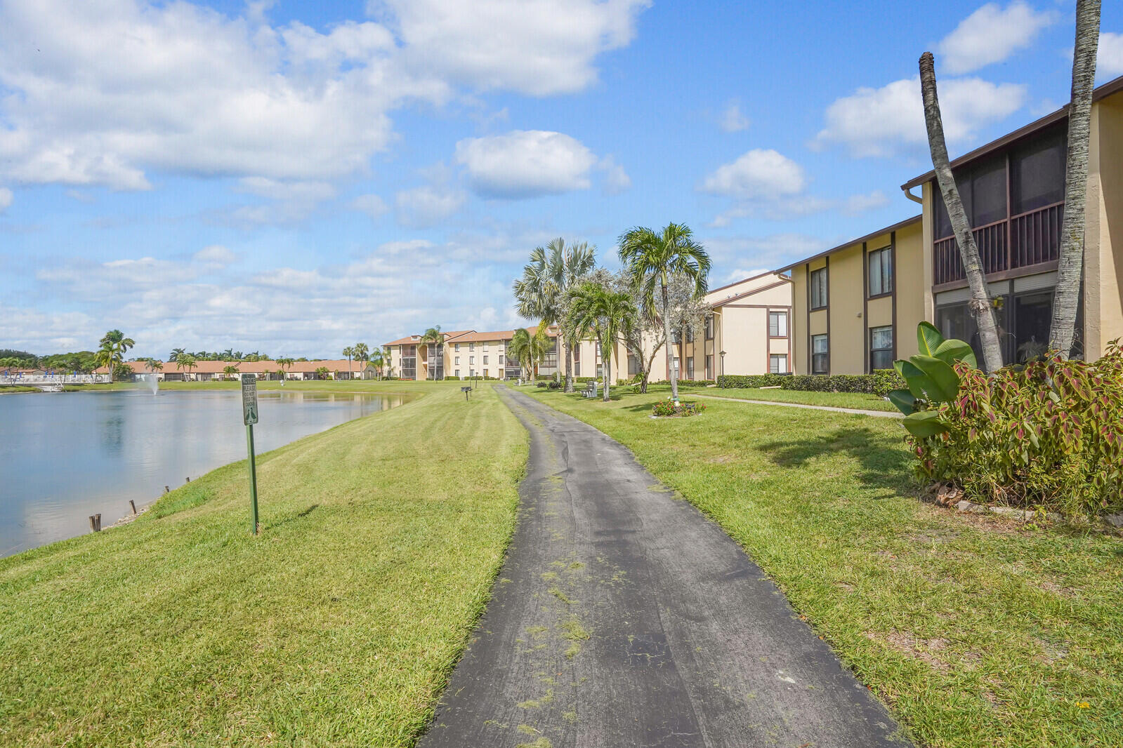 826 Sky Pine Way, Unit G2 Greenacres, FL 33415 - Photo 2 of 30 a view of a lake with a building in the background