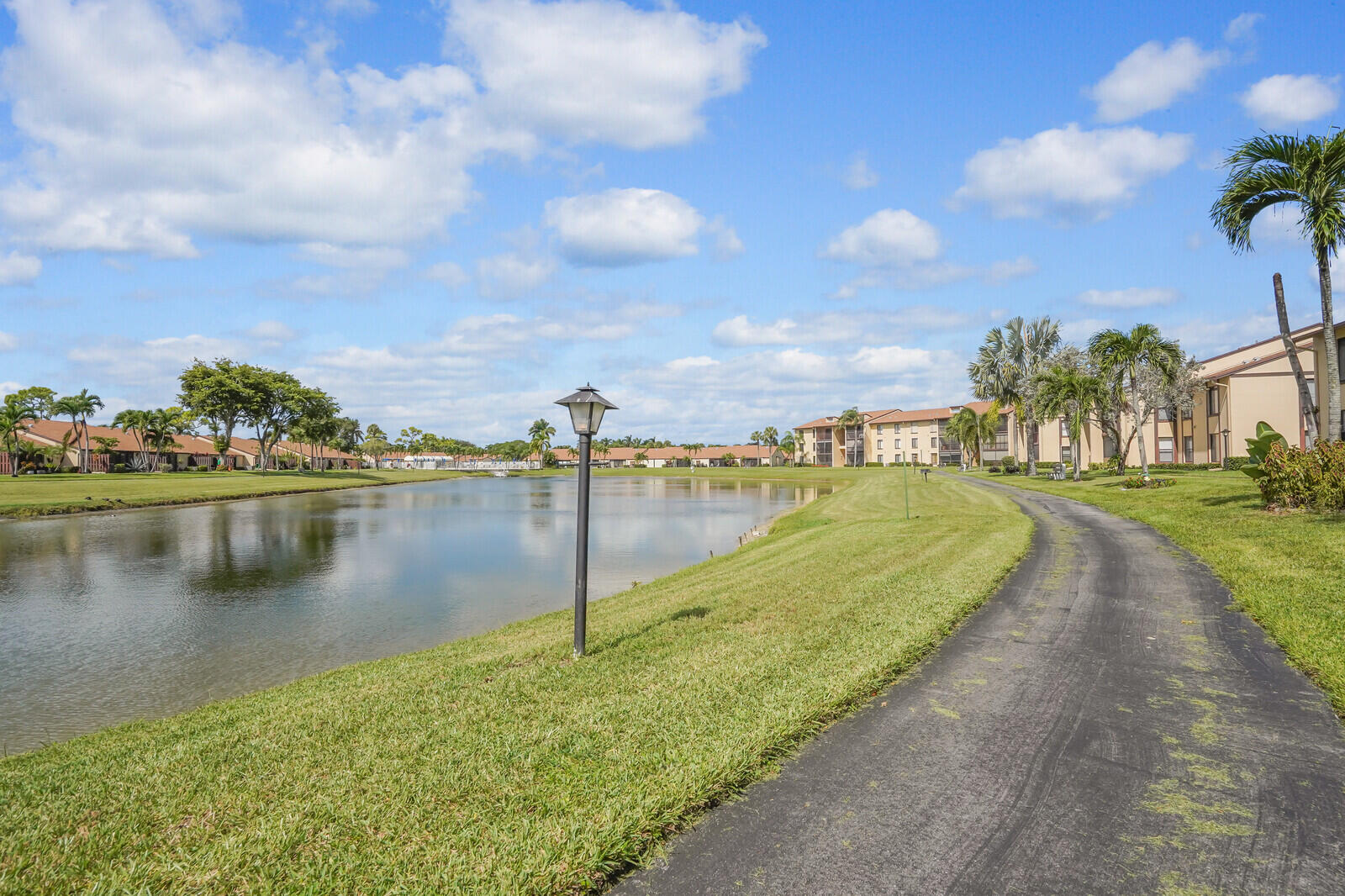826 Sky Pine Way, Unit G2 Greenacres, FL 33415 - Photo 3 of 30 a view of a lake with a yard