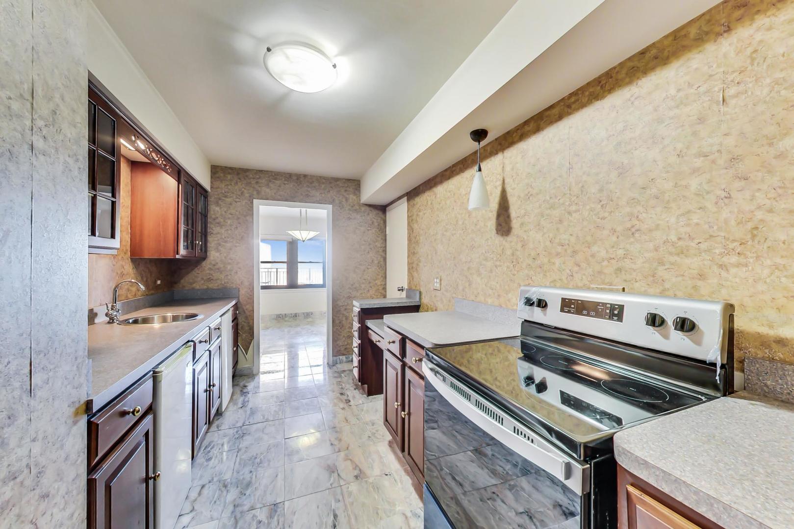 1350 North Astor Street, Unit 9B Chicago, IL 60610 - Photo 13 of 25 a kitchen with sink stove and cabinets