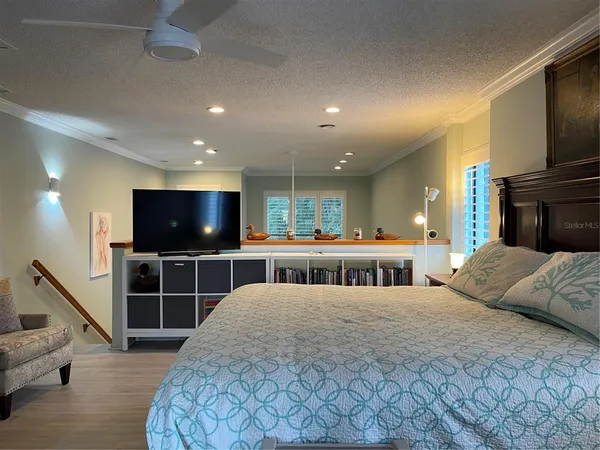 a large bedroom with bed and window