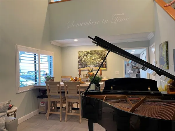 a table and chairs in a room and window