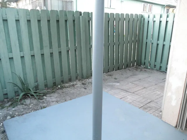 a view of backyard with tub