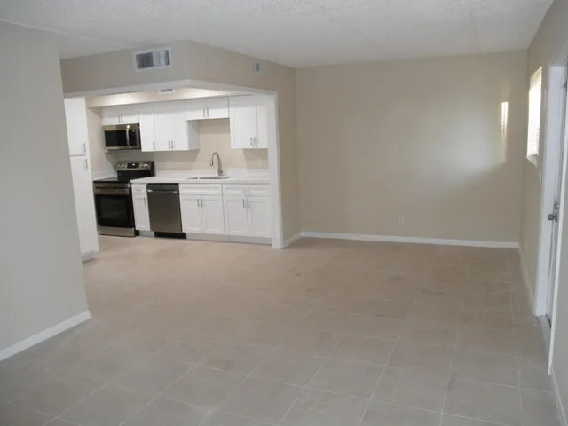 a kitchen with a sink cabinets and stainless steel appliances