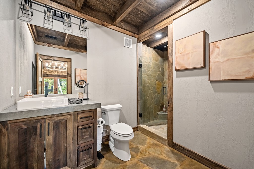 184 Spence Road Epworth, GA 30541 - Photo 27 of 62 a bathroom with a granite countertop sink toilet a mirror and shower
