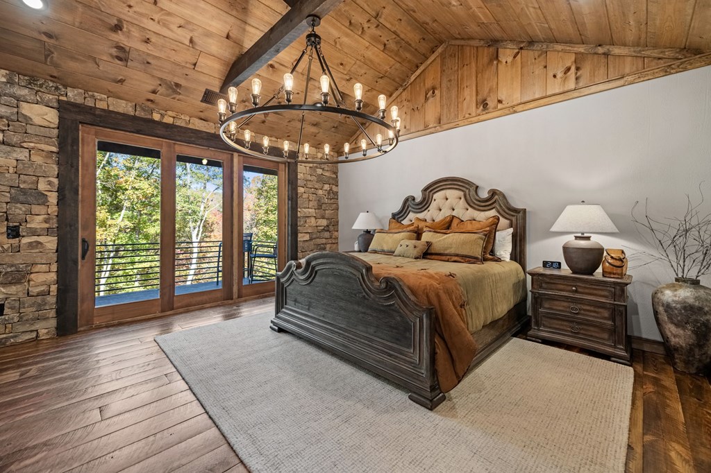 184 Spence Road Epworth, GA 30541 - Photo 28 of 62 a spacious bedroom with a bed and a chandelier
