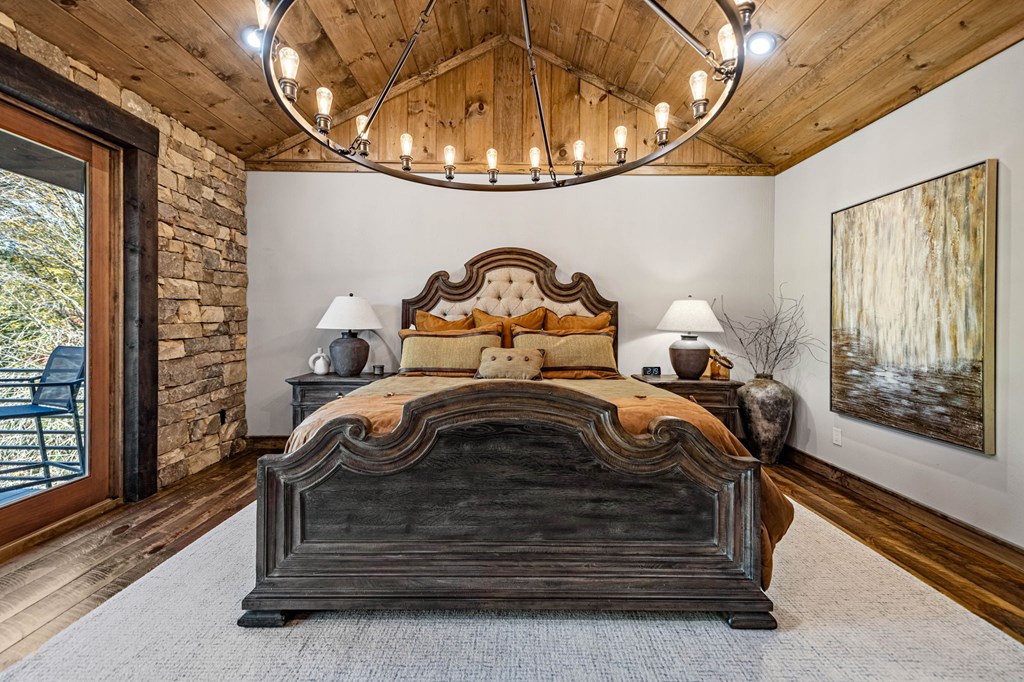 184 Spence Road Epworth, GA 30541 - Photo 29 of 62 a bedroom with a bed and a chandelier