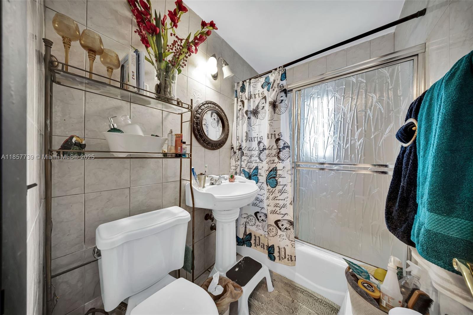 20415 Southwest 114th Court Miami, FL 33189 - Photo 12 of 23 a white toilet sitting next to a bathroom sink and a shower