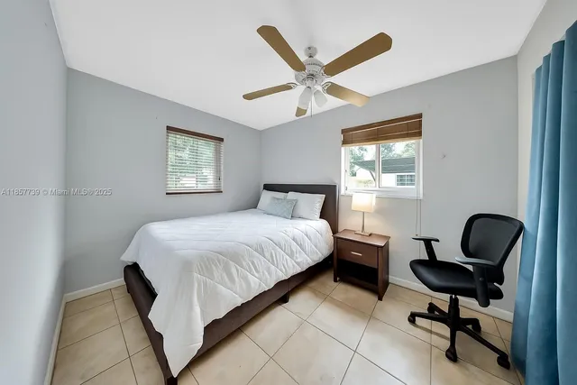 a bedroom with a bed chair and window