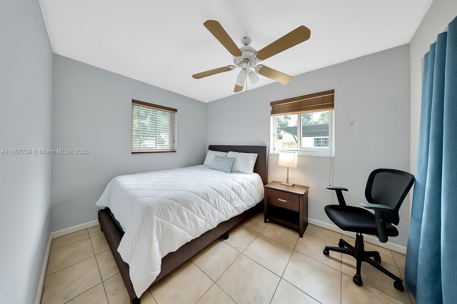 20415 Southwest 114th Court Miami, FL 33189 - Photo 15 of 23 a bedroom with a bed chair and window