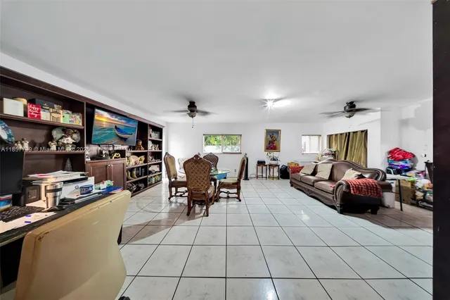 a living room with lots of furniture and a flat screen tv