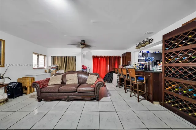 a living room with furniture and a bookshelf