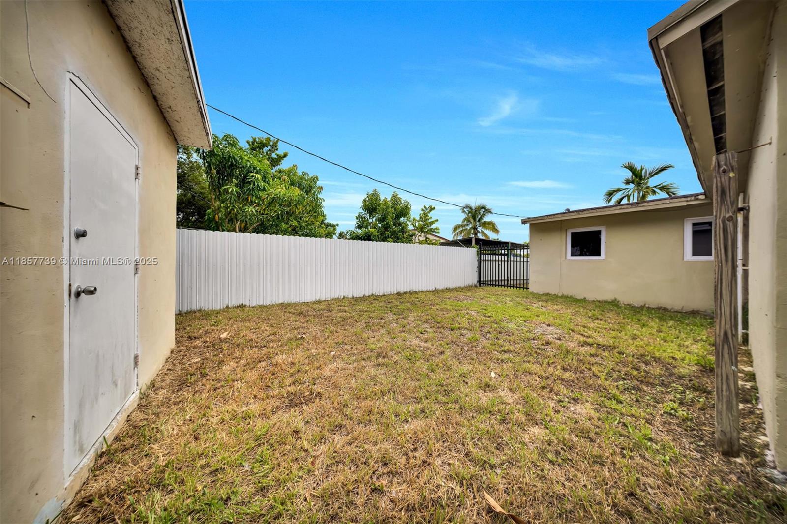 20415 Southwest 114th Court Miami, FL 33189 - Photo 23 of 23 a view of house with backyard and wooden fence