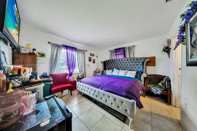 a bedroom with furniture and a flat screen tv