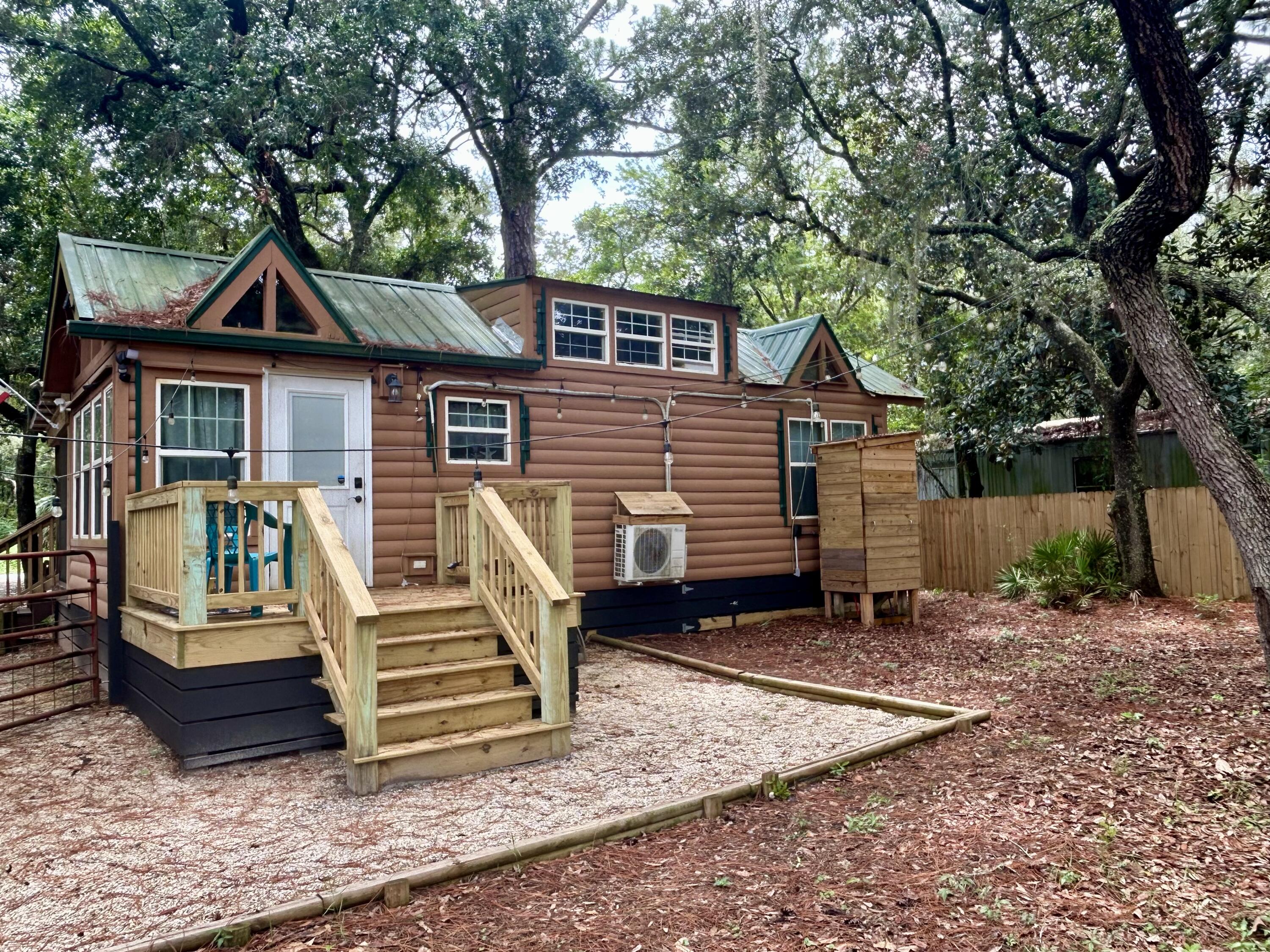 155 Madge Lane Santa Rosa Beach, FL 32459 - Photo 16 of 17 a view of a house with a backyard and chairs