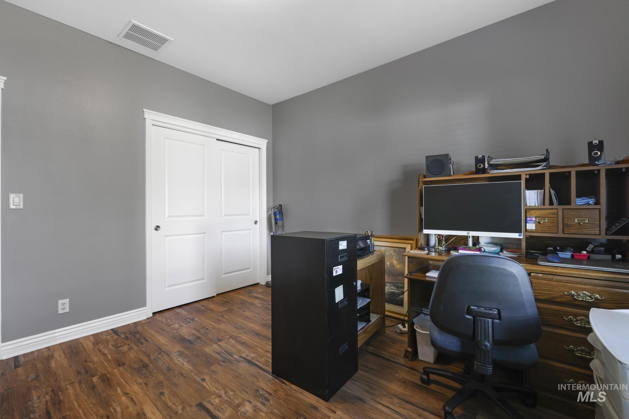 467 Wildrose Loop Twin Falls, ID 83301 - Photo 22 of 46 Interior room featuring wood-finish flooring, neutral gray walls, and white trim