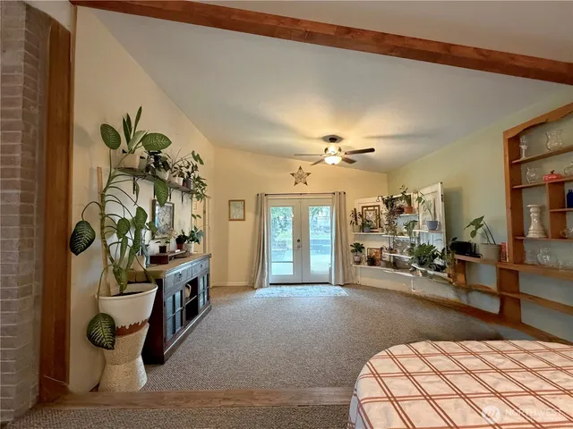 a living room with furniture a chandelier and a rug