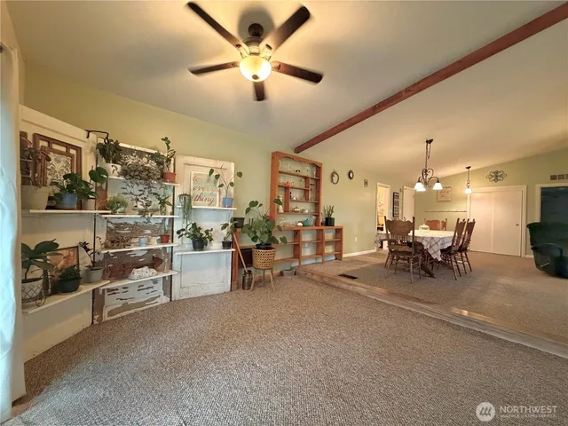a view of a livingroom with furniture and a fan
