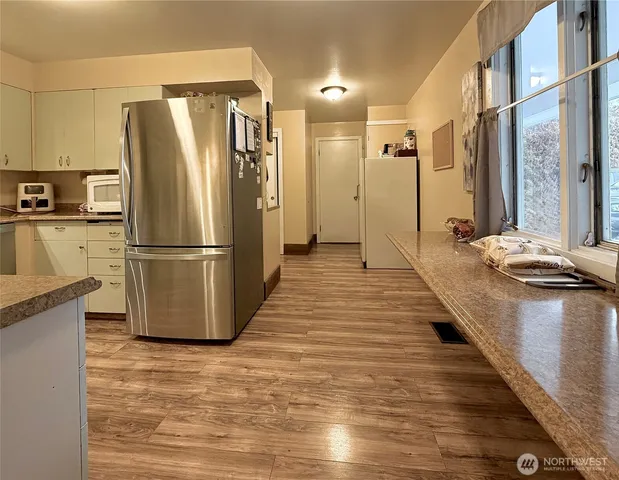 a kitchen with stainless steel appliances a refrigerator a sink a stove and cabinets