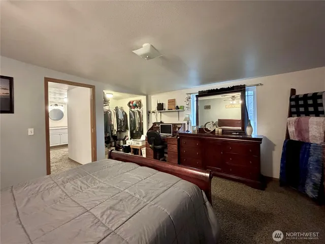 a bed room with a bed and a dresser