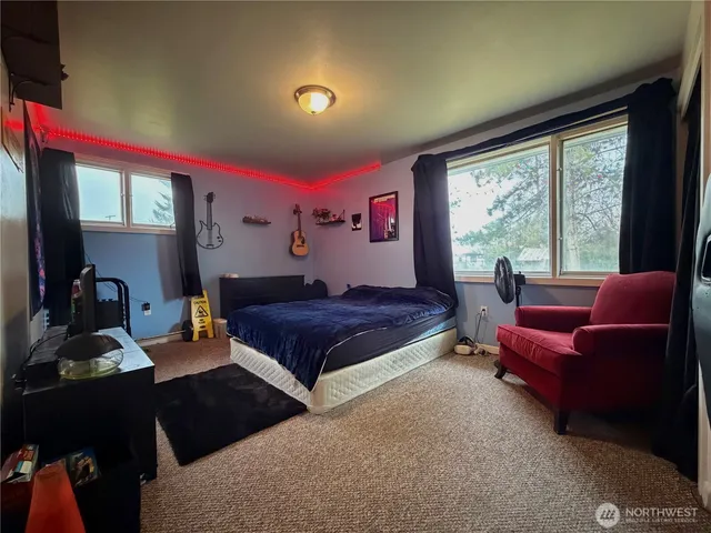 a bedroom with a bed and a couch