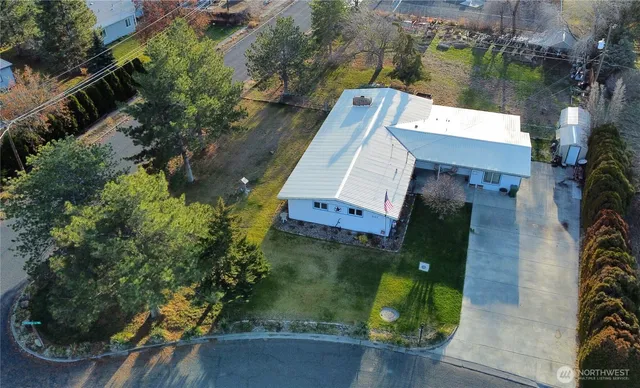 an aerial view of a house with a yard