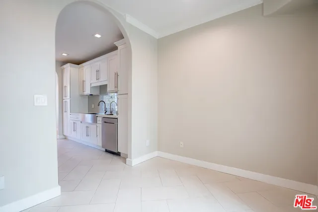 a view of a kitchen with a sink and dishwasher a refrigerator with wooden floor