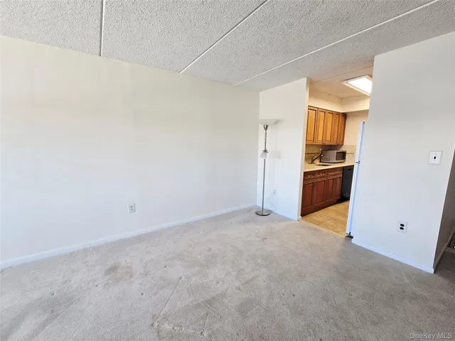 a kitchen with granite countertop a refrigerator and a sink