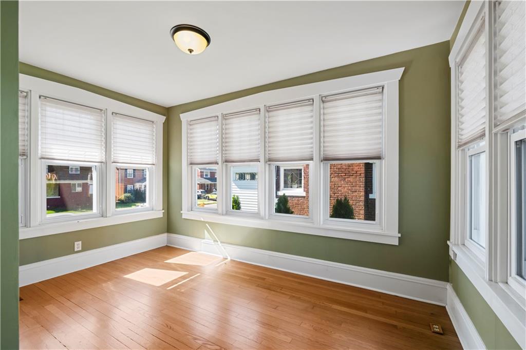 935 Alcoma Street Sharon, PA 16146 - Photo 11 of 28 an empty room with wooden floor and windows