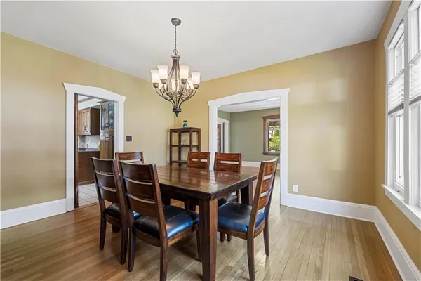 a view of a dining room with furniture wooden floor and chandelier