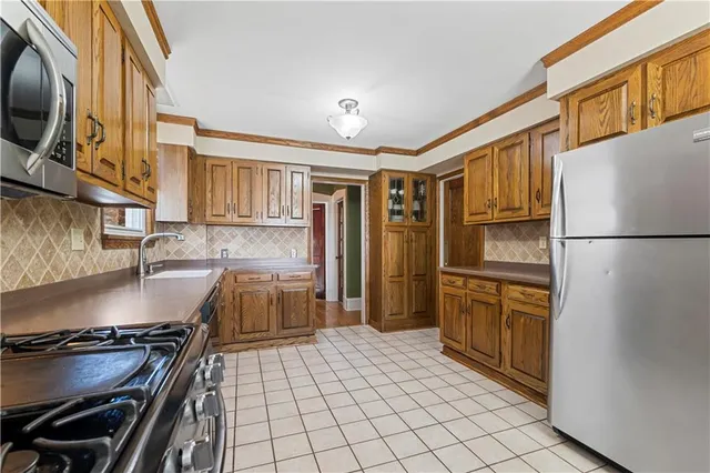 a kitchen with stainless steel appliances granite countertop a refrigerator stove and sink
