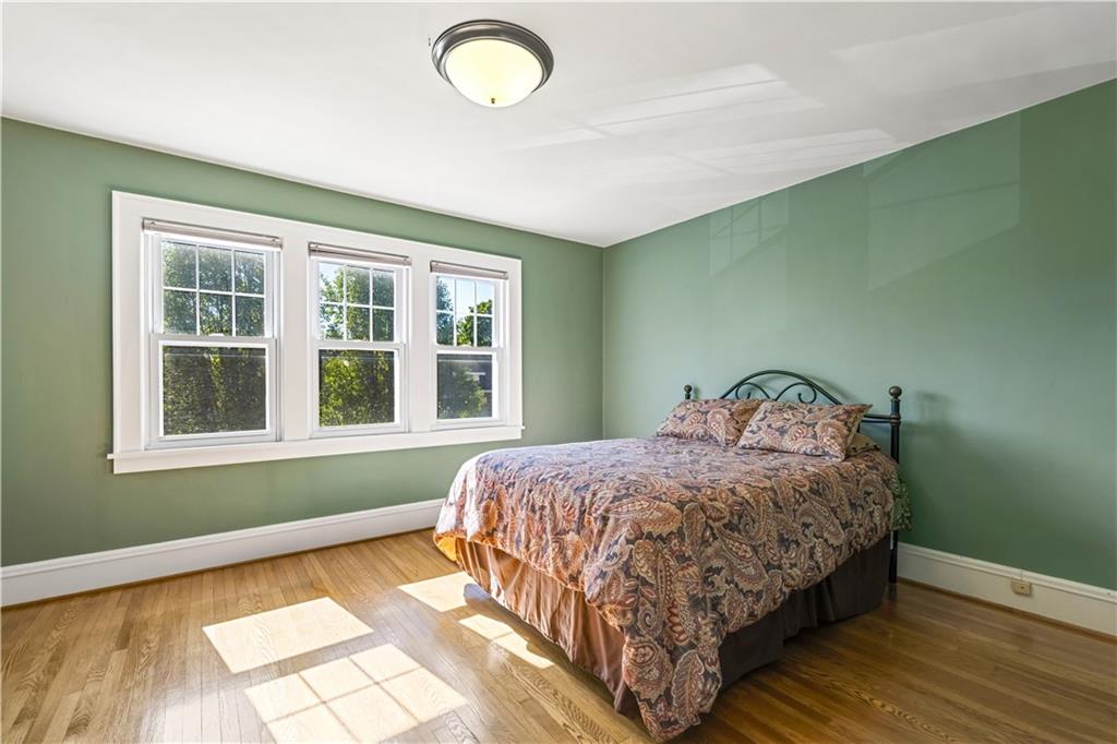 935 Alcoma Street Sharon, PA 16146 - Photo 19 of 28 a bedroom with a bed and wooden floor