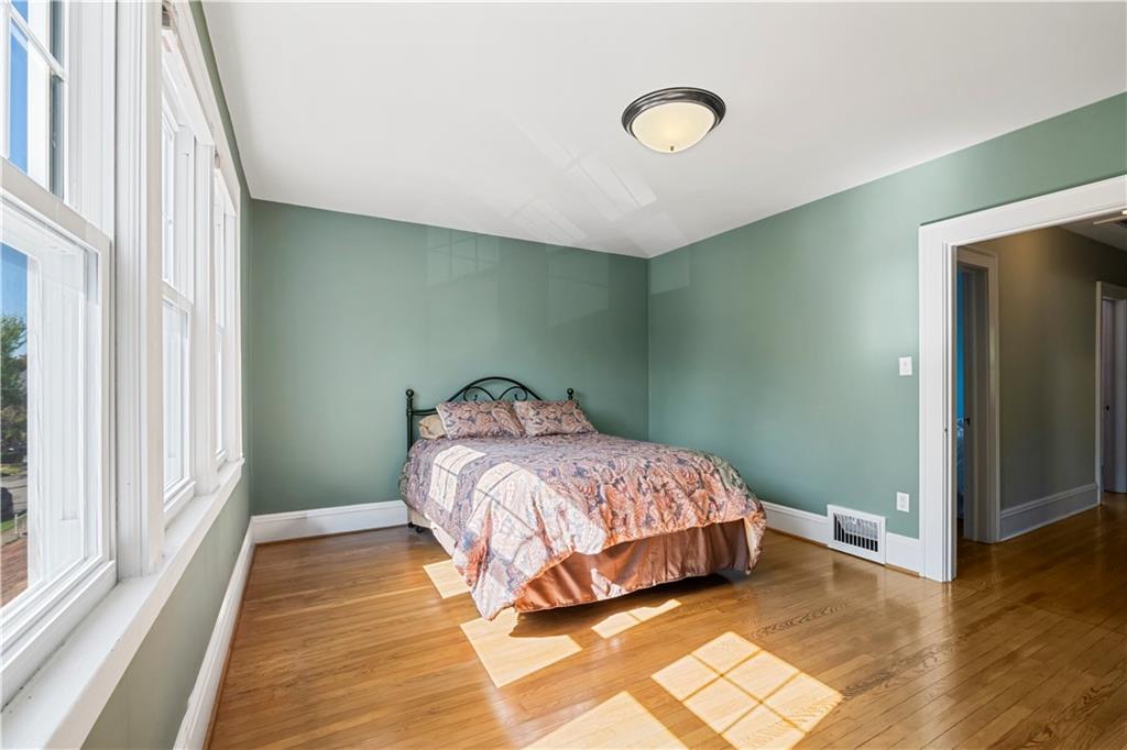 935 Alcoma Street Sharon, PA 16146 - Photo 20 of 28 a bedroom with a bed and wooden floor