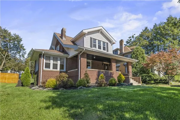 a front view of house with yard and green space