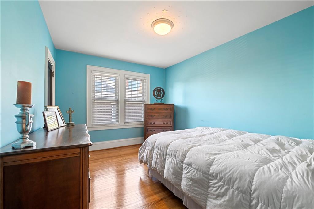 935 Alcoma Street Sharon, PA 16146 - Photo 21 of 28 a bedroom with a bed and wooden floor