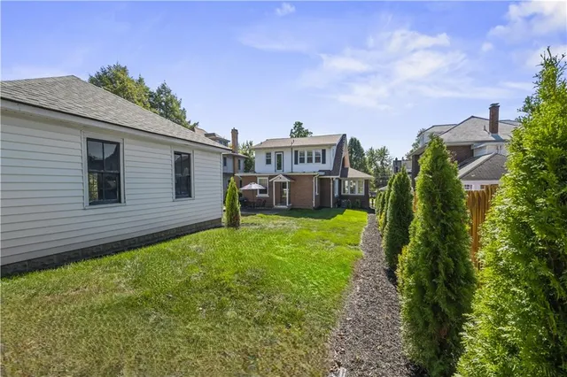 a view of a house with a backyard
