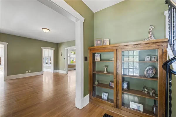 a view of an entrance and a livingroom with wooden floor