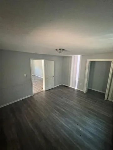 a kitchen with granite countertop a refrigerator and a sink