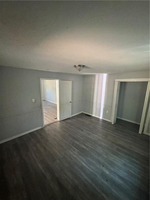 711 Highway 162 Covington, GA 30016 - Photo 12 of 25 an empty room with wooden floor and windows