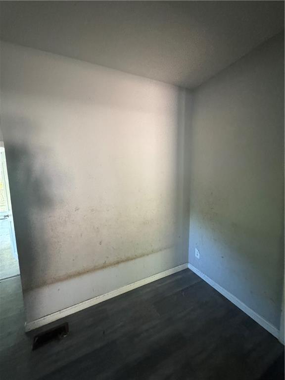 711 Highway 162 Covington, GA 30016 - Photo 16 of 25 an empty room with wooden floor and door