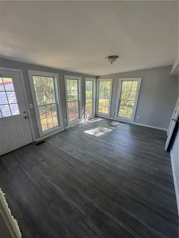 a view of a room with wooden floor and window