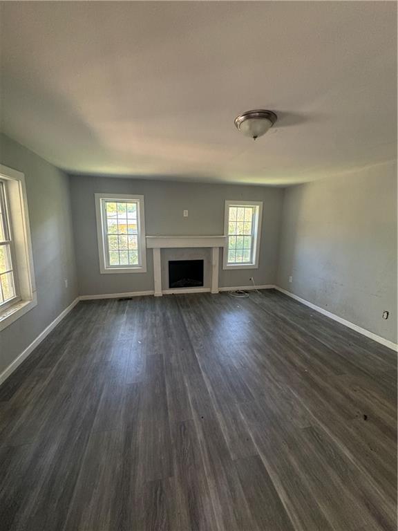 711 Highway 162 Covington, GA 30016 - Photo 8 of 25 an empty room with wooden floor and windows